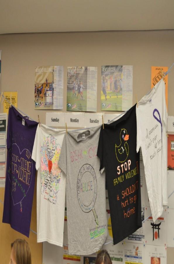 Display of shirts designed last year for the clothesline project