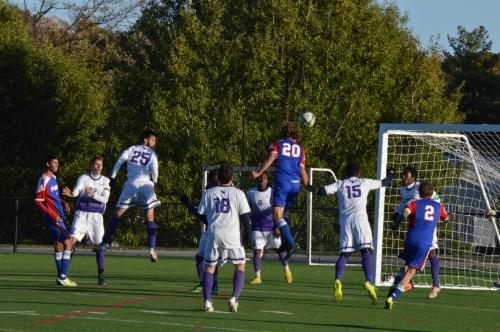 Defensive player, Mason Kostick leaps to hit a header.