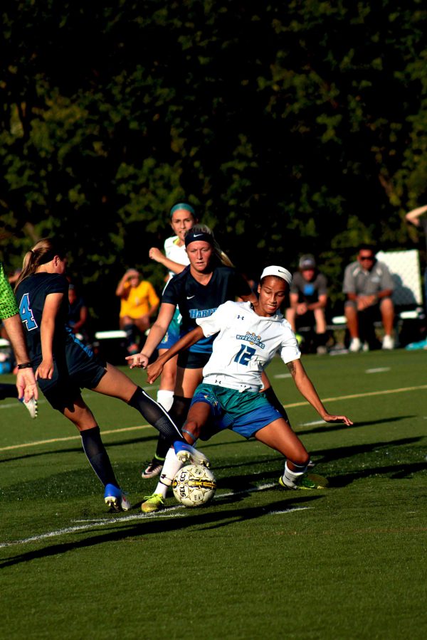 AACC Women’s Soccer forward and co-captain Bailey Foust reaches out to take the ball from her opponent.