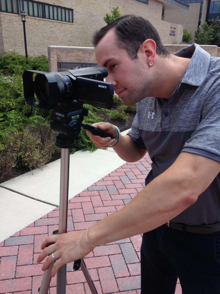 Sports information specialist Zach Malone tests the department's new camera