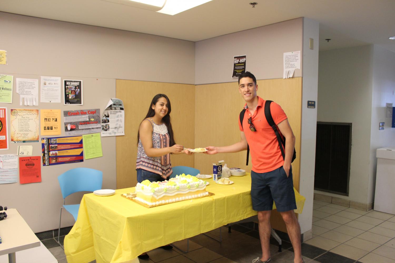 Diana Perez, president of Latino Club, is handing out tres leches cake in honor of Hispanic Heritage month.