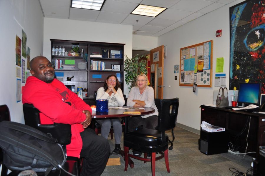 Ron Easley (left) and Gwinn Spence work under Loretta Lawson-Munsey at the lounge-like recovery center to help other students escape drug addictions.