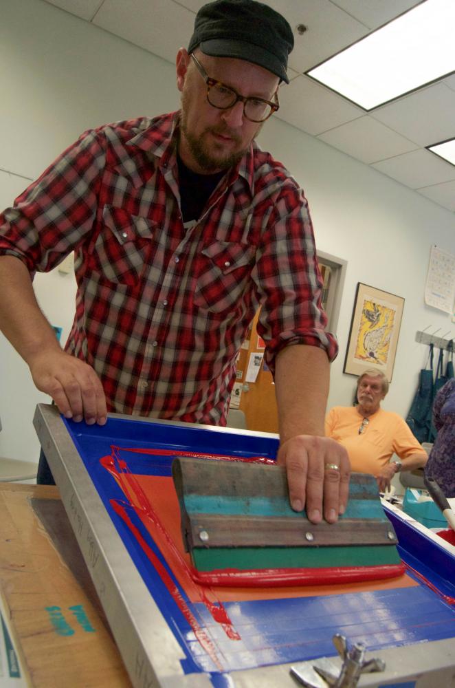 Michael Byzewski shows his screen printing process before his talk.