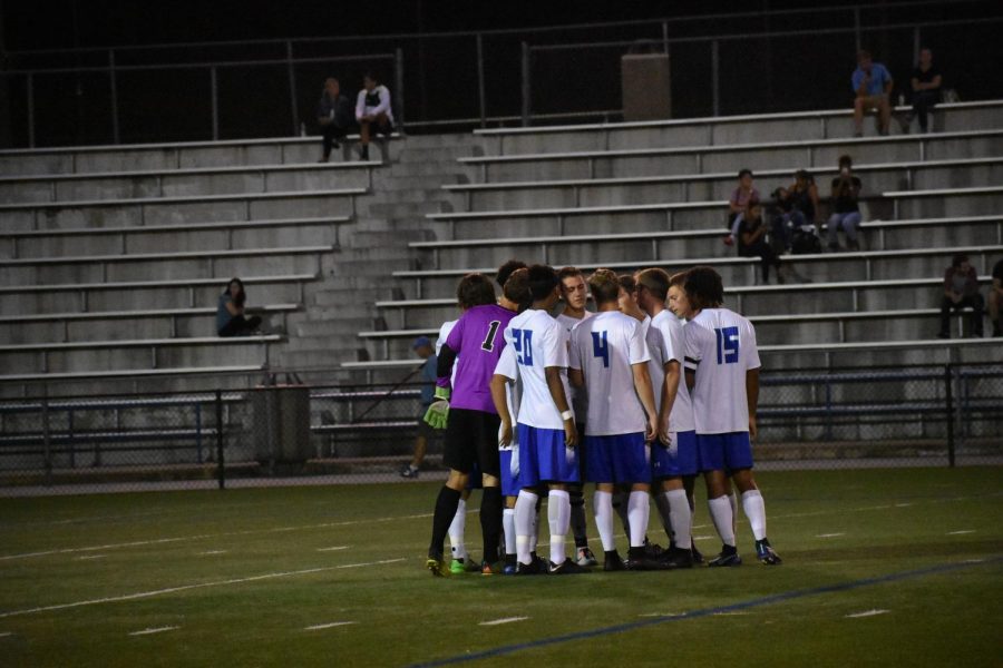 Men’s Soccer players huddle before a game.
Photo by Sarah Alonso