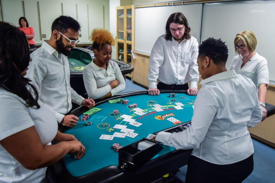 Mohammad Zaidi (left), Taylor Williams (center-left), Joseph Williams-Overton (center-right) and Tanjanigua Swindell practice running games with each other in the Act 1 Blackjack Dealer class, Games 300.
