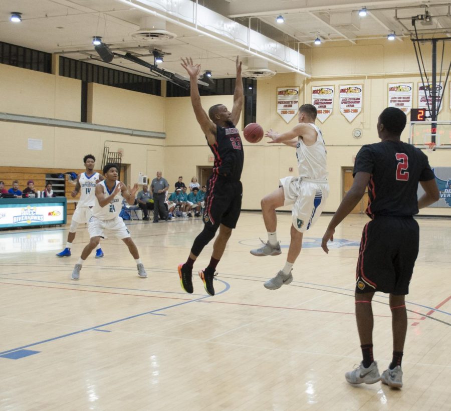 First-year forward Jacoby Rojas passes the ball to a teammate in a game against Community College of Baltimore County Dundalk.
