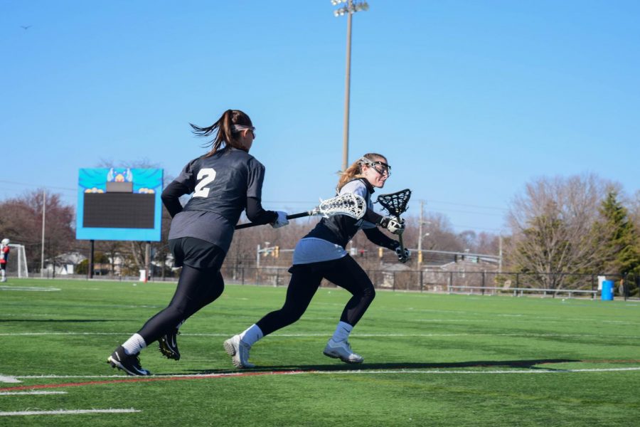 Lacrosse players Payton Baronella-O’Toole and MacKenzie Schwartz practice for a game. Some athletes will be able to count developmental courses in their GPAs next fall. 
