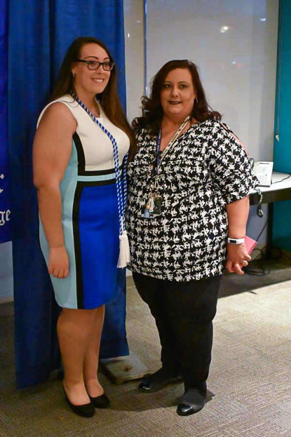 Mia Rogers-Vega—a second-year cyber forensics student and one of this year’s Epsilon Chi inductees—poses with her mother, Sheila Rogers-Vega, after the ceremony.