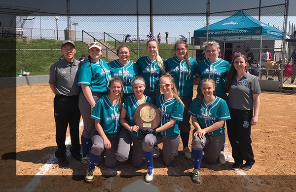 AACCs softball team—pictured here with its 2018 NJCAA Region 20 Championship trophy for District III—will become Division II starting in the spring.