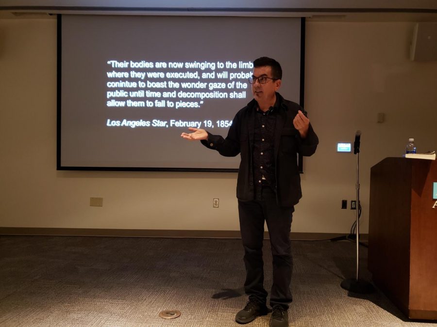 Internationally renowned photographer Ken Gonzales-Day speaks to a packed lecture hall in Cade about the racial issues his photos capture. 