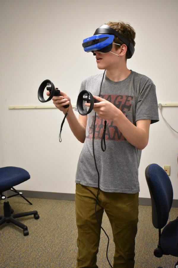 AACC’s Campus Current Tech Editor Alex Fregger tries out a virtual reality headset for the first time in the college’s VR room in the CALT Building. 