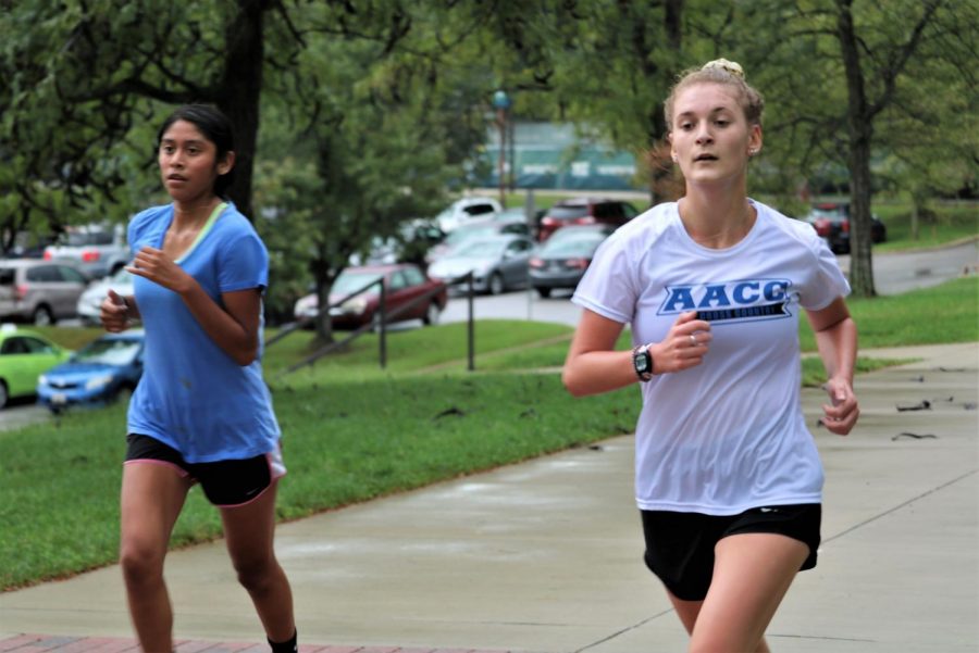 Cross Country runners Leslei Garcia Mendez, left, and Emily Jacobsen keep in shape by running on campus.