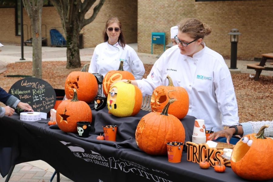 Club adviser Carrie Svoboda and second-year culinary student Emily Parent arrange pumpkins at todays culinary event. 