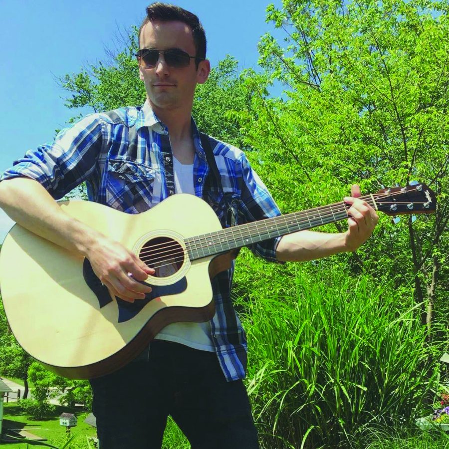 Second-year transfer studies student Giordano DeFilippo plays his guitar, which he says is the best gift he ever received.