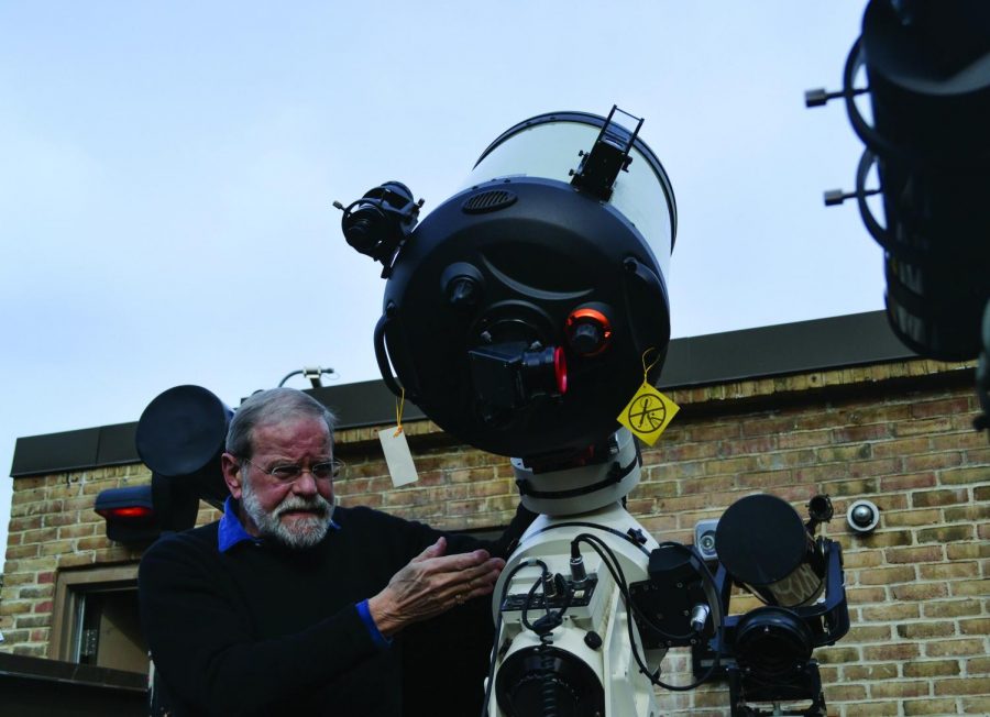 Professor Tom Wilbur sets up one of six telescopes AACC owns as part of the Observatory.