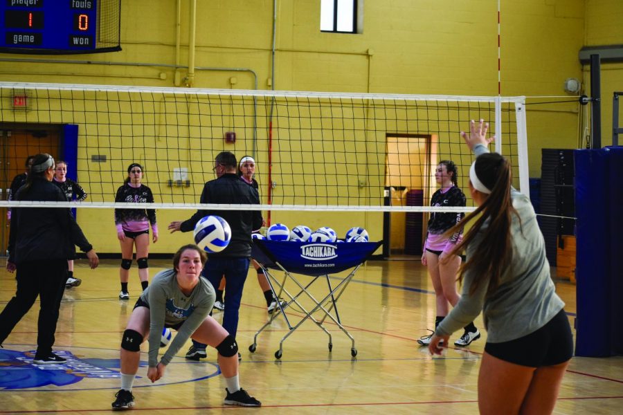 Women’s Volleyball middle hitter Deanna Valerian (left) and outside hitter Brittney Guy practice before their last games.