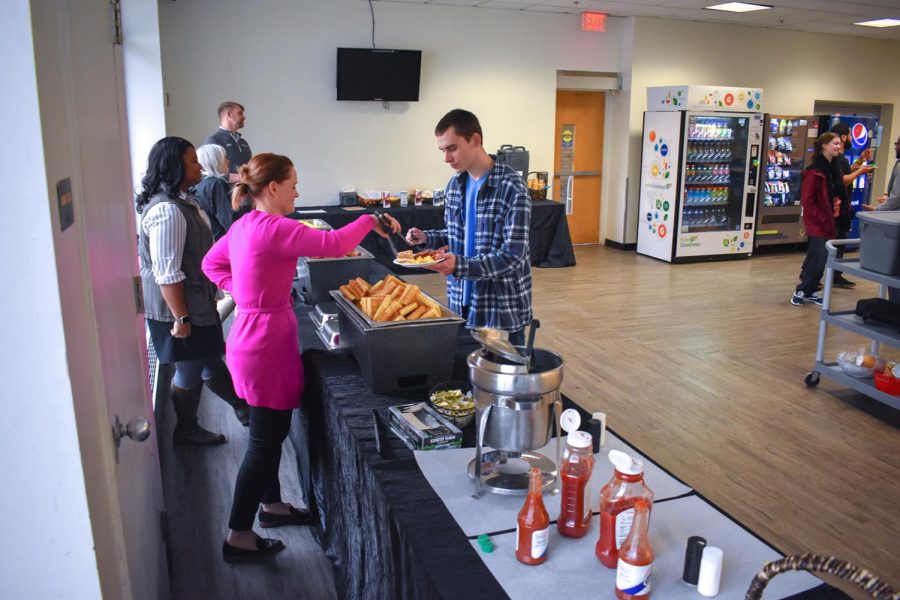 Timothy Aquilino, 4th year fine arts student, gets a plate of hot food filled from the free breakfast event.