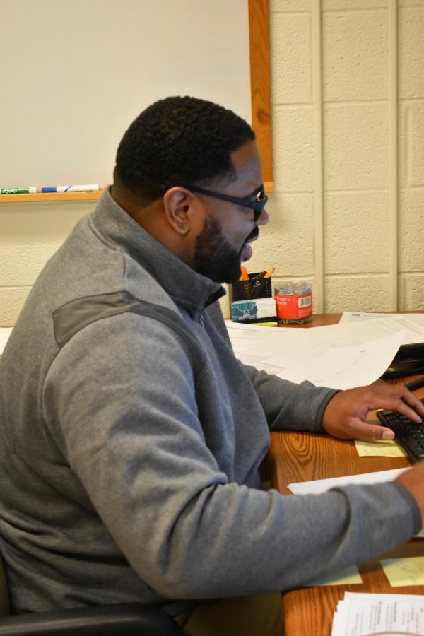 Trey Anderson works from his office in the gym. He is the new student athlete success coordinator.