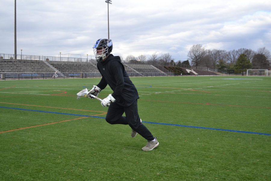 Second-year communications student Noah Reem, midfielder, prepares for the lacrosse season by working out on the turf. The team opens the season at home on Feb. 23. 