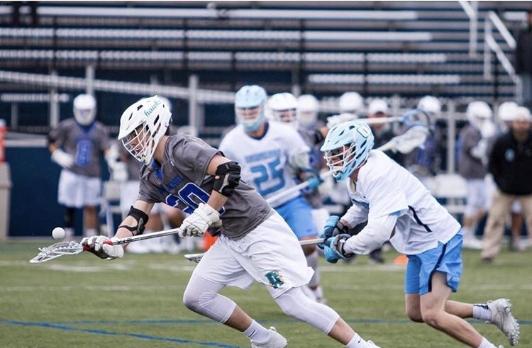 All-American lacrosse player Nick Karnes wins a face-off against Onondaga Community College last season. Karnes will not return to AACC in 2019.