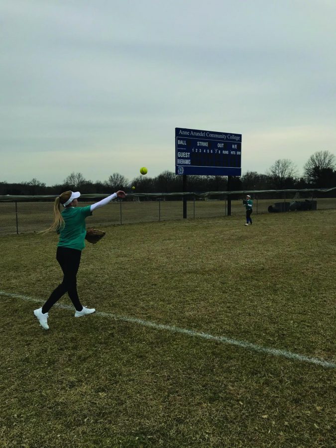 Softball player Sylvia Frye throws to her teammates.