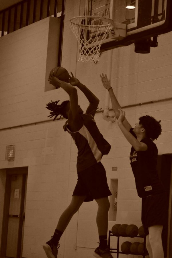 Riverhawks Men's Basketball athletes, Dayvon Cuffey, a second-year forward (left), and Deondre McNeill, a second-year center, practice together for their big games.