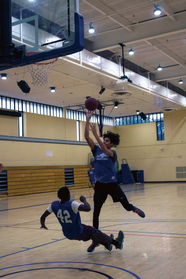 Deondre McNeill, a second-year center and undecided student, shoots on Joe Chase, a first-year guard and physical therapist student.