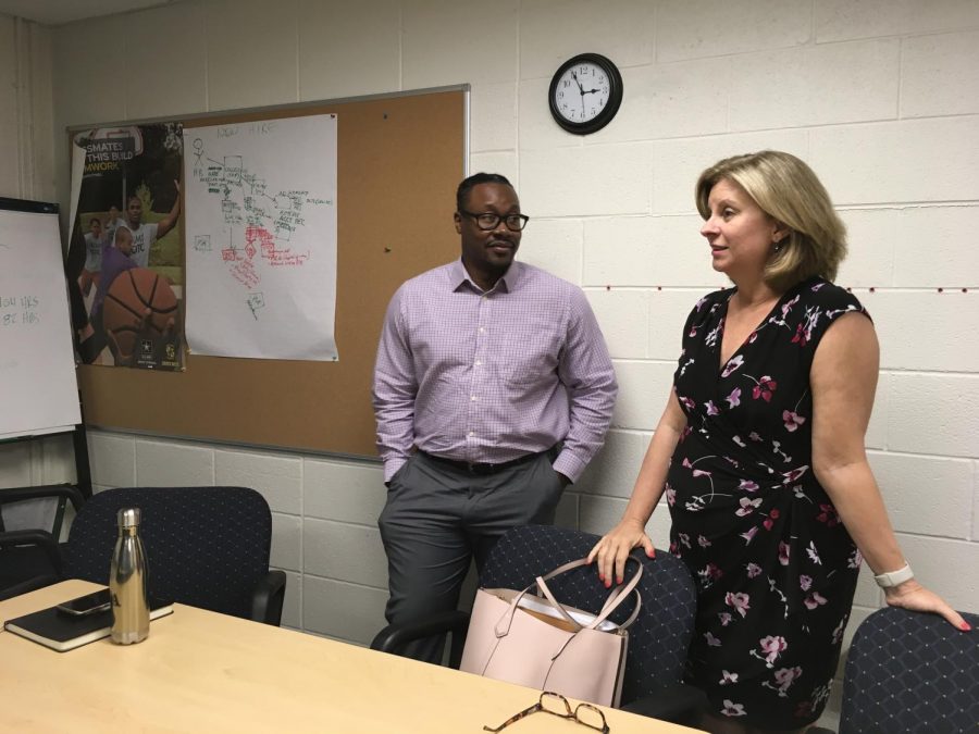 Assistant deans Danny Hoey (left) and Stacy Korbelak chat before a meeting. 