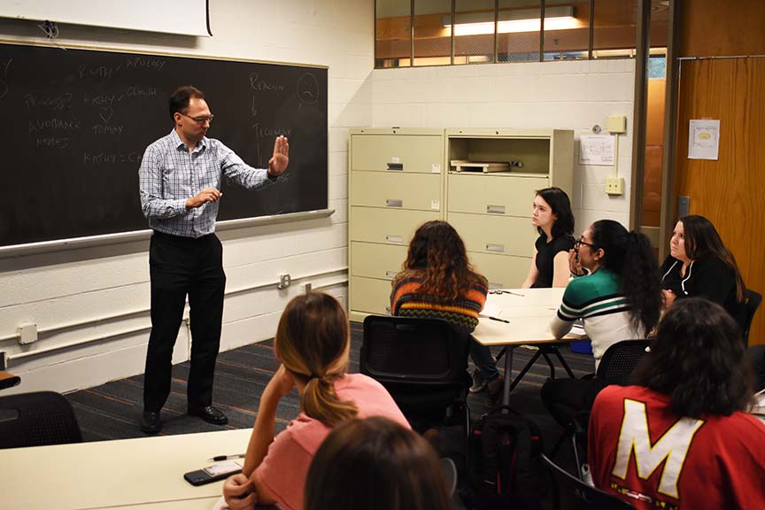 Eighteen courses with 600 sections are following a model course format to ensure consistency from class to class. Pictured: English professor Wayne Kobylinski with a class.