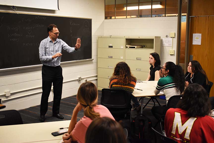 Eighteen courses with 600 sections are following a 'model course' format to ensure consistency from class to class. Pictured: English professor Wayne Kobylinski with a class.