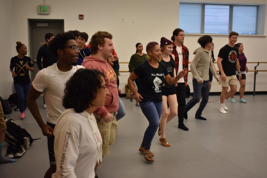 Students+and+faculty+dance+under+the+instruction+of+Haitian+band+members+on+Oct.+3.