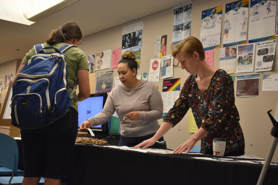 The Health & Wellness Center staff helps students deal with stress and gives out bracelets and gratitude journals. Above, Outreach Coordinator Rodaelys Rojas (left) and Peer Health Educator Madeline Piper with a student. 