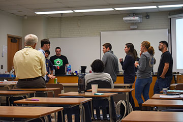 Speaker Alex Angelelli teaches students about the chemistry of coffee. 