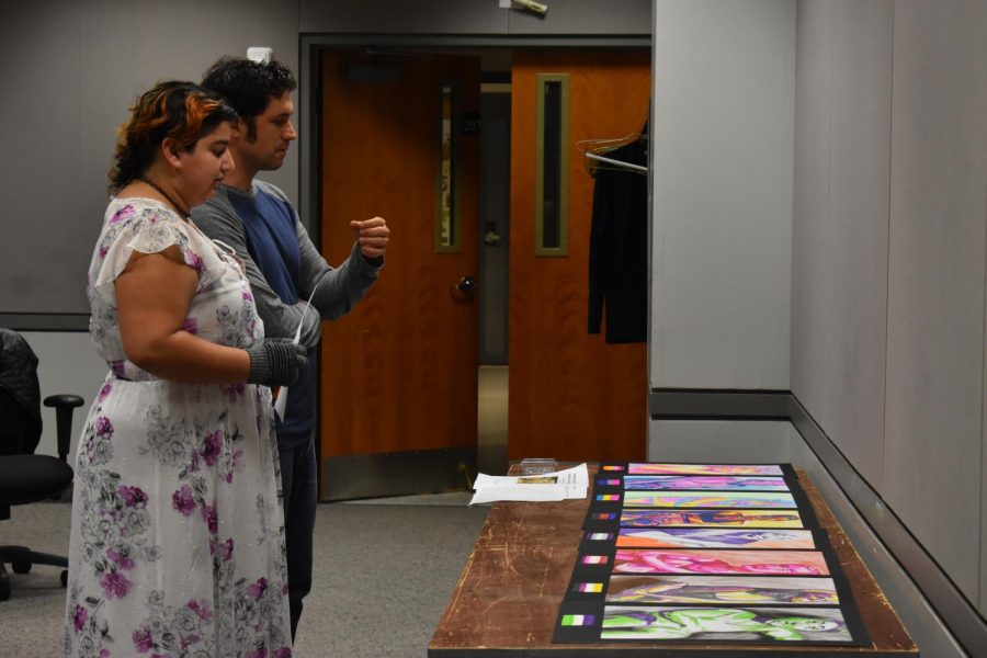 Chair of Drawing and Painting Matt Klos critiques third-year studio arts student Erica Romero's portfolio pieces. 