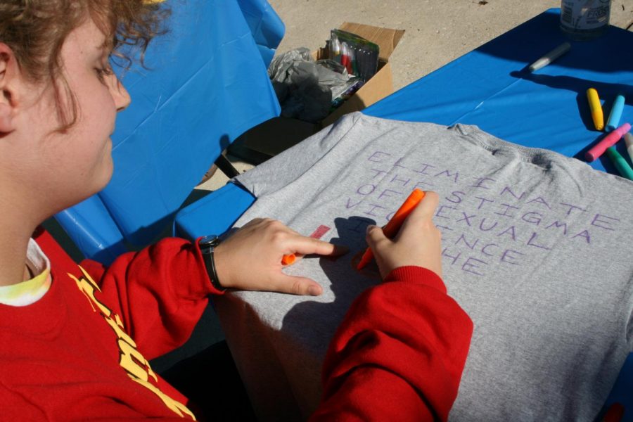 A student draws a t-shirt campaigning against the stigma of sexual assault survivors.