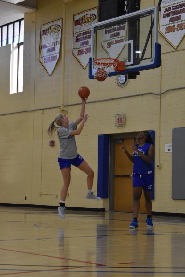 Second-year transfer studies student Sarah Healy, left, and first-year nursing student Ruth Marshall practice for the basketball season.