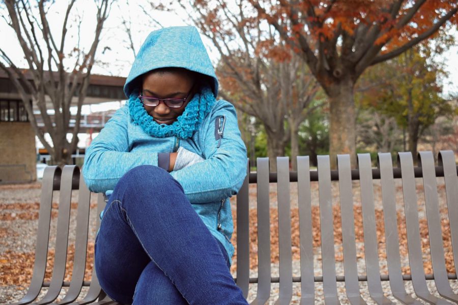 Second-year creative writing student Magdaline Thompson bundles up against the cold weather.