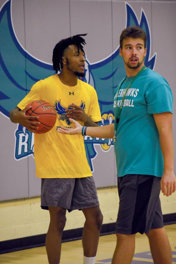 Campus Current reporters regularly interview coaches and players for Men’s Basketball forward Keith Wyatt Jr. (left) works with assistant coach Clinton Smith.