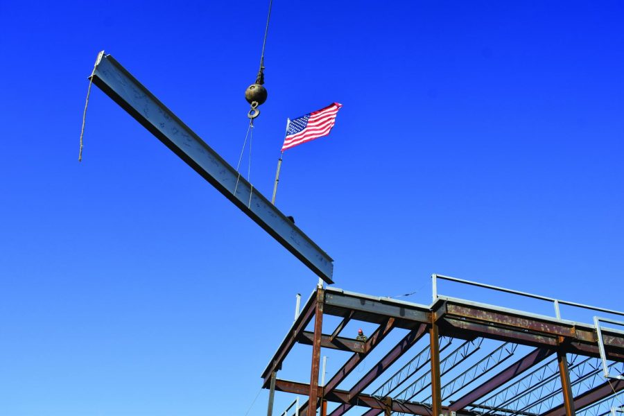 Whiting-Turner places the final piece of steel in the frame of the new Health and Life Sciences Building on campus. 
