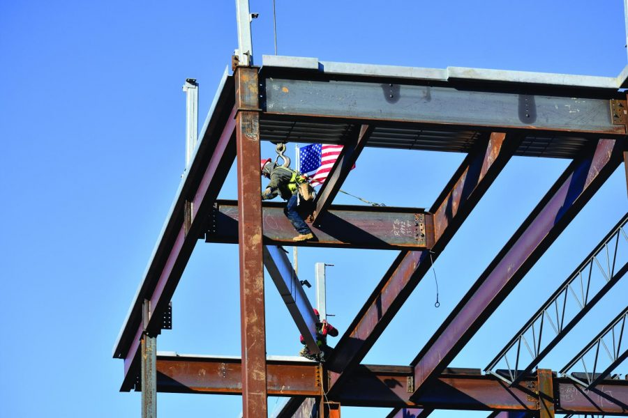 Whiting-Turner places the final piece of steel in the frame of the new Health and Life Sciences Building on campus. 
