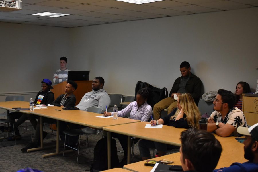 Students listen to a religious speaker talk about forgiveness at a weekly Experience Apostolic Campus Ministries club meeting.