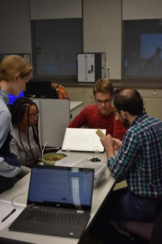 Computer Science Club members talk during a meeting. 