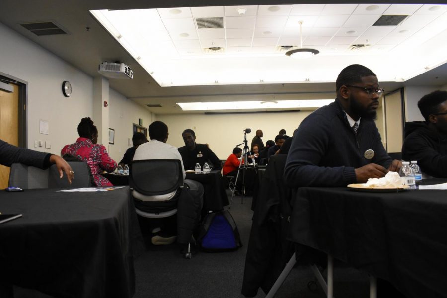 Students talk during the 10th annual Black Male Summit. 