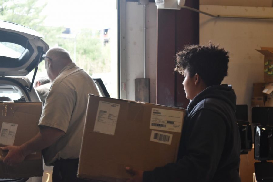 AACC maintenance staff loads boxes of medical supplies the college donated to local hospitals.