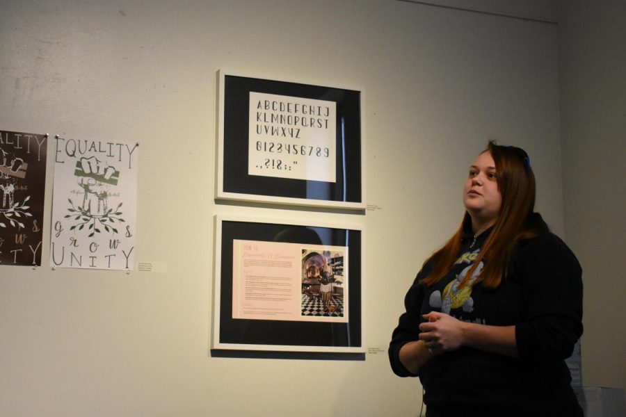 Second-year visual arts student Jess Gordon-Young explains her art to attendees at the Art of Women Invitational Exhibit.
