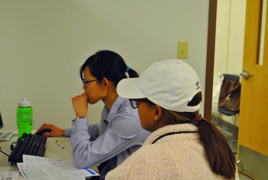 Second-year business administration student Yen Truong helps a member of the community with her taxes.