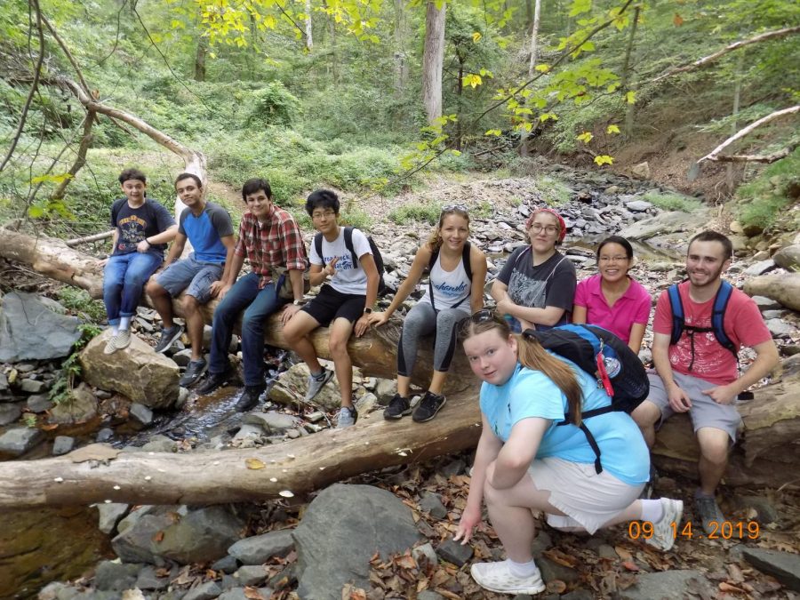 AACC Adventure Club members take a break from hiking the Patapsco Valley trail last fall. The club president plans to organize another hike this semester. 