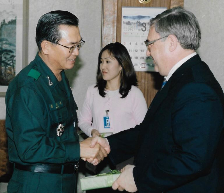 Dr. John Bodnar, an adjunct instructor and student at AACC, says he likes talking to younger students about his experience in the military. Shown, Bodnar meets with a representative of the  South Korean Biological Warfare intel office.