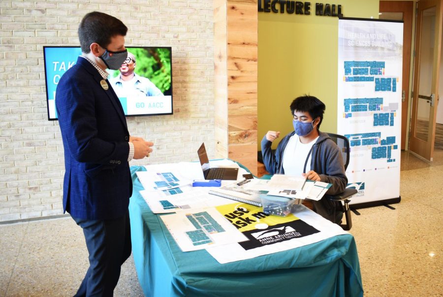 David Phan, a third-year landscape architecture student, served as a temporary “just ask” employee, answering questions about the new Health and Life Sciences building at the start of the semester. He talks with with a Chick-fil-A representative who helped open the the restaurant inside the new building.