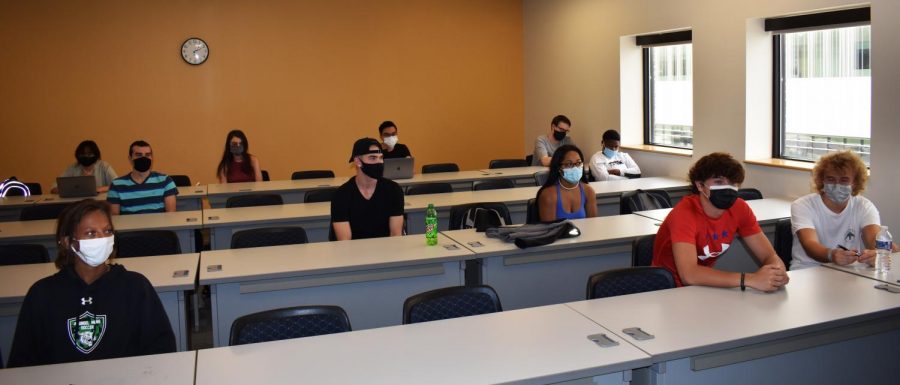 The college is aiming to have 50% of course sections on campus in the spring semester. Shown, students in a communications course wear masks to every class this semester. 